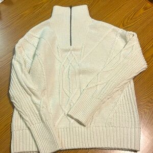Cream cable knit sweater with zip up collar. Size Medium